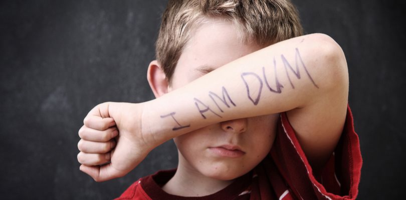 A child covering his face with his forearm